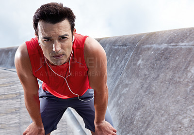 Buy stock photo Man, break and earphones for run in portrait, outdoors and athlete for performance training in city. Male person, serious face and rest from workout on street, relax and listen to music for exercise