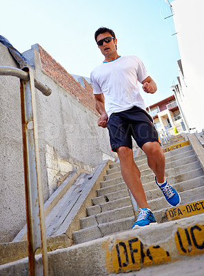 Buy stock photo Man, stairs and earphones for running outdoors, sports and athlete for performance training in city. Male person, full body and sunglasses for workout in town, cardio and listen to music for exercise