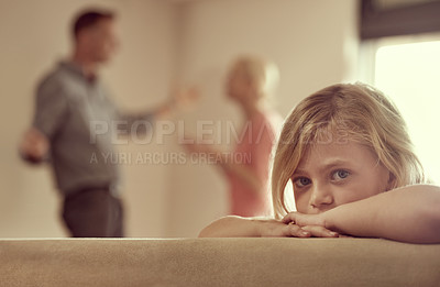 Buy stock photo Shot of a little girl looking unhappy as her parents argue in the background