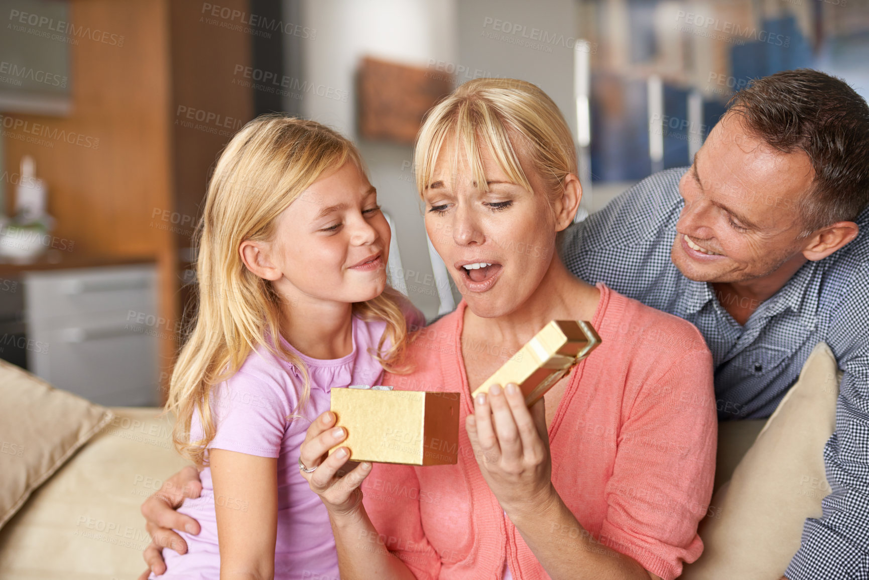 Buy stock photo Surprise, father and child with present for mom on birthday or opening a box on mothers day. Family, gift and dad with kid in home giving woman unique package of gold to show gratitude, care or love