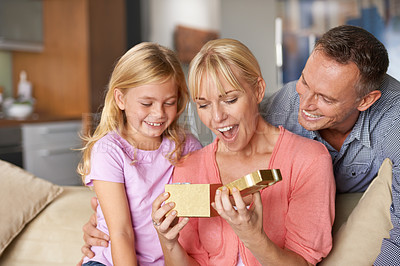 Buy stock photo A little girl giving her mom a gift on her birthday