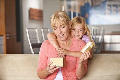 Buy stock photo Mothers day, surprise and hug with gift, daughter and smile in house while closing eyes and excited. Mom, kid and present on sofa, home and happy for birthday or embrace for love, fun and couch