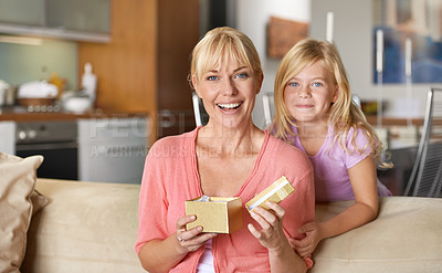 Buy stock photo Mothers day, portrait and daughter with gift, sofa and smile in house while closing eyes and excited. Mom, kid and present on sofa, home and happy for birthday or playing peekaboo for love and fun