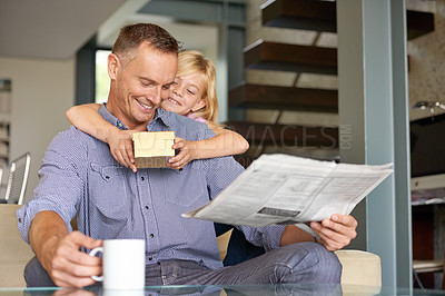 Buy stock photo Man, daughter and gift for fathers day in home, happy and present for gratitude or appreciation. Daddy, child and smile for love and care in package for birthday, hug and reading newspaper with tea