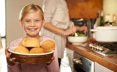 Buy stock photo Portrait, young girl and cooking with mother, kitchen and bread basket for family dinner. Smile, proud and development of food education, preparation and nutrition or bonding with mom at home 