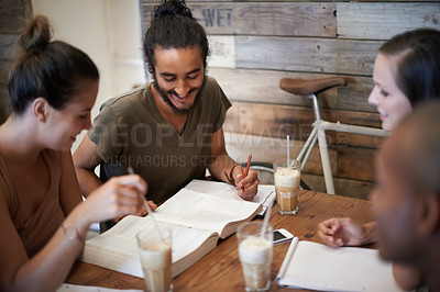 Buy stock photo Cropped shot a group of friends studying together at a coffee shop