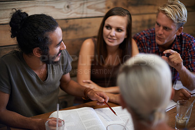 Buy stock photo Cropped shot a group of friends studying together at a coffee shop