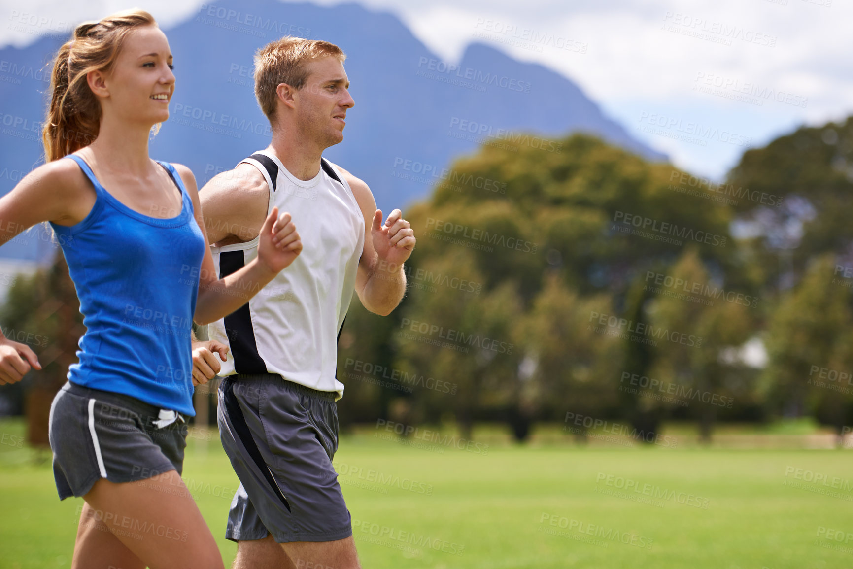 Buy stock photo Man, woman and running for exercise on field with smile for speed, wellness and training in summer. People, coach or personal trainer with runner for workout, fitness and together on grass for health
