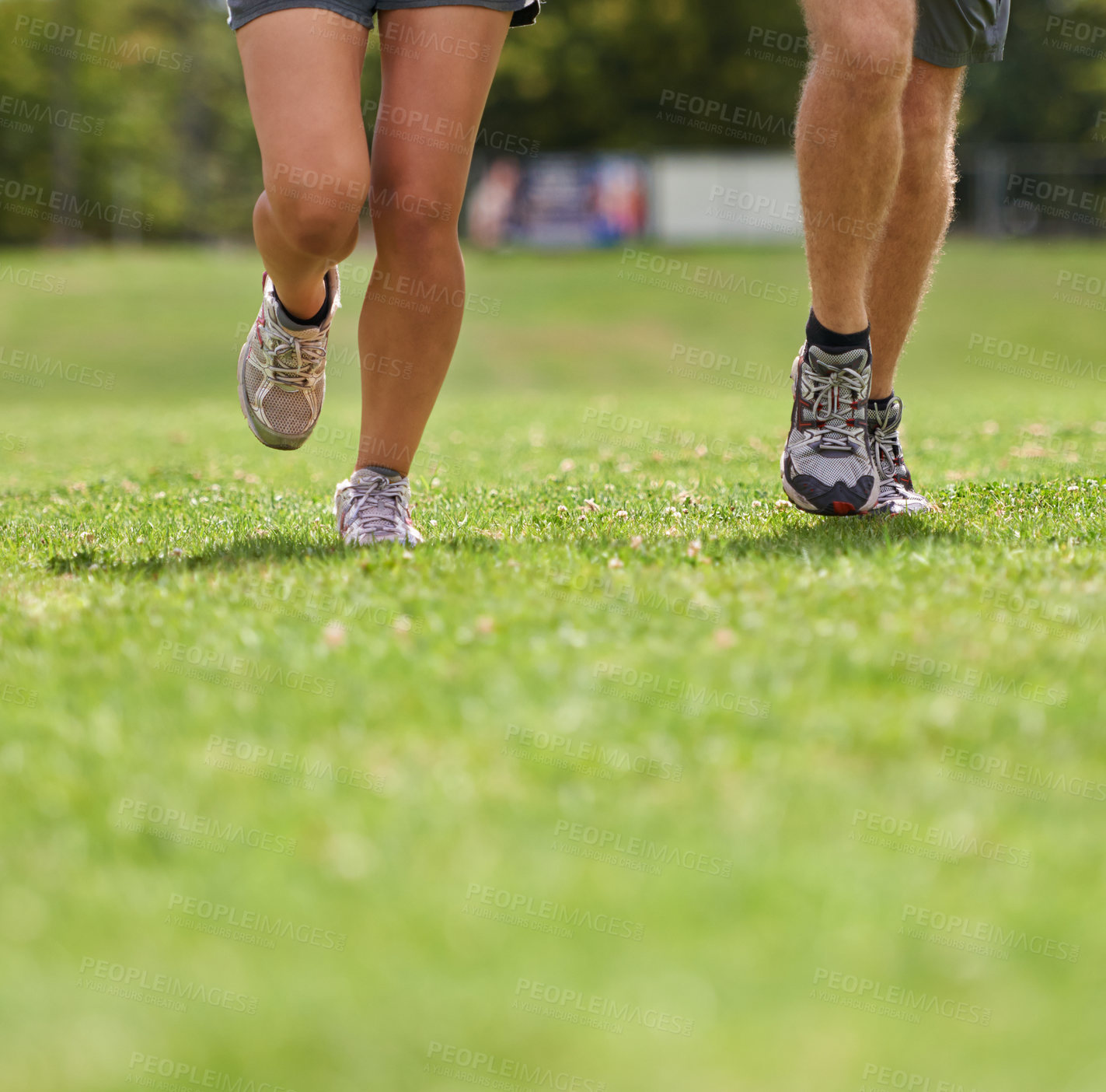 Buy stock photo People, running shoes and closeup on grass for workout together in summer for health, wellness or training. Person, runner and partner with feet on field for exercise, fitness and speed with sneakers