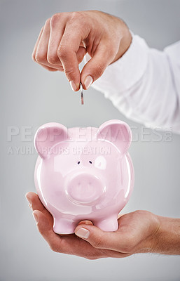 Buy stock photo Hands, coin in piggy bank and saving for future, person has financial freedom or budget with money on grey background. Investment, finance for growth and development with security and emergency fund