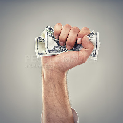 Buy stock photo Closeup, hand and money for finance, greed and capitalism for business on grey background in studio. Fist, cash and dollar to invest, pay or loan for bid opportunity, trading and financial market