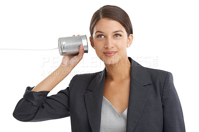 Buy stock photo Studio shot of an attractive young businesswoman listening to her tin can telephone