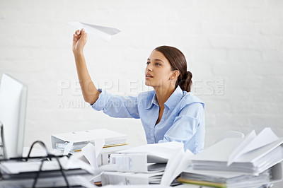 Buy stock photo Corporate, businesswoman and paper plane at desk, sitting and thinking while working. Employee and paperwork with files in professional workspace, procrastination and avoid with distraction game