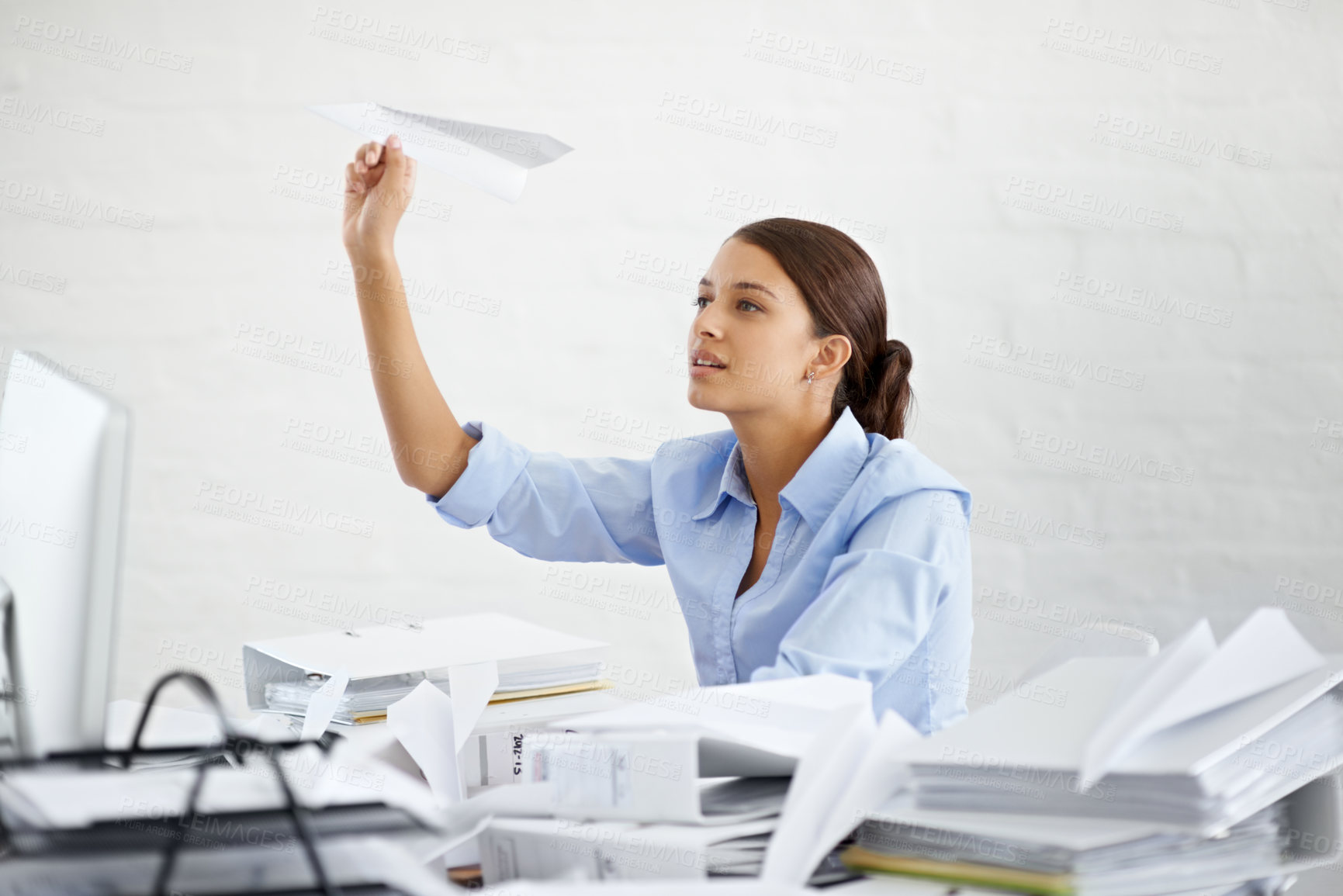 Buy stock photo Corporate, businesswoman and paper plane at desk, sitting and thinking while working. Employee and paperwork with files in professional workspace, procrastination and avoid with distraction game