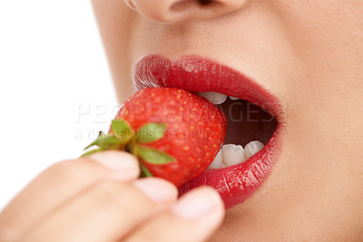 Buy stock photo Person, mouth and bite with strawberry, red lipstick or cosmetics for nutrition on a white studio background. Closeup of woman, teeth or organic fruit with makeup for diet, natural fiber or glow