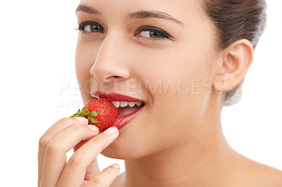 Buy stock photo Cropped portrait of a beautiful young woman biting into a strawberry