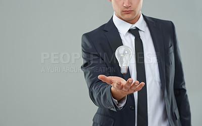 Buy stock photo Business man, light bulb and ideas for company, entrepreneur with innovation and problem solving for energy saving. Hologram, solution and corporate goals for knowledge and power on grey background