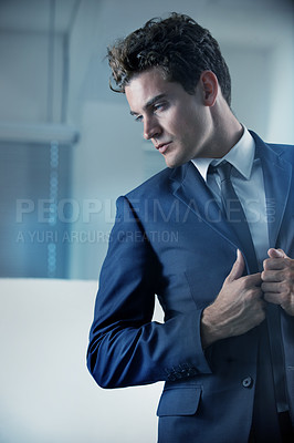 Buy stock photo Cropped shot of a handsome young businessman wearing a suit