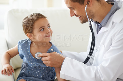 Buy stock photo Shot of a handsome male doctor with an adorable young girl for a  patient