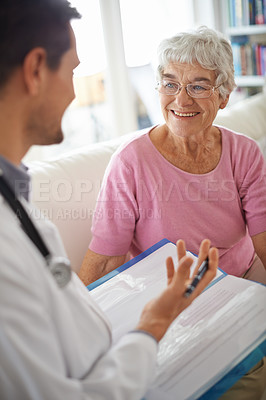 Buy stock photo A smiling senior woman chatting with her GP during an appointment