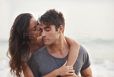 Buy stock photo Cropped shot of an affectionate young couple at the beach