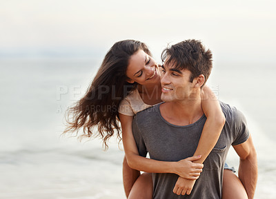 Buy stock photo Cropped shot of an affectionate young couple at the beach