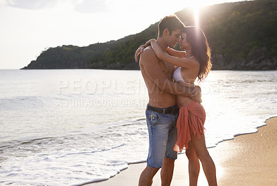 Buy stock photo A young couple on a calm and tranquil beach
