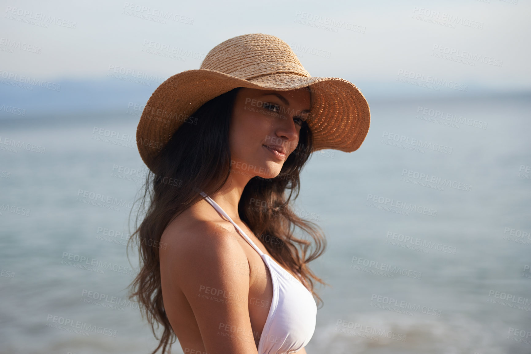 Buy stock photo Smile, holiday and woman with hat at beach for travel adventure, thinking and relax in nature. Sunshine, summer and happy face of girl at ocean on vacation with water, reflection and resort in Bali.