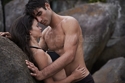 Buy stock photo Couple, beach and rocks with love, relationship and romance with swimwear and bikini. Man, woman and date with holiday, vacation and adventure with nature for cape town summer travel and sensuality