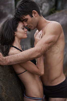 Buy stock photo Cropped shot of an affectionate young couple at the beach