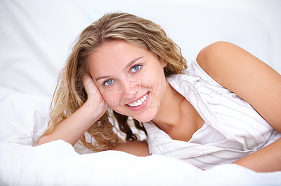 Buy stock photo Female person, smile and portrait while laying on bed to relax, bedroom and closeup with happiness and happy. Woman, wavy hair and beauty while calm, peace and confident while inside home in linen