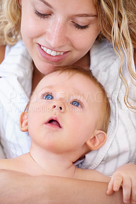 Buy stock photo Baby, bonding and happy with mother, relaxing and love together with child and care for motherhood. Infant, mom and smile for affection, nurture and home for growth and babysitting with family