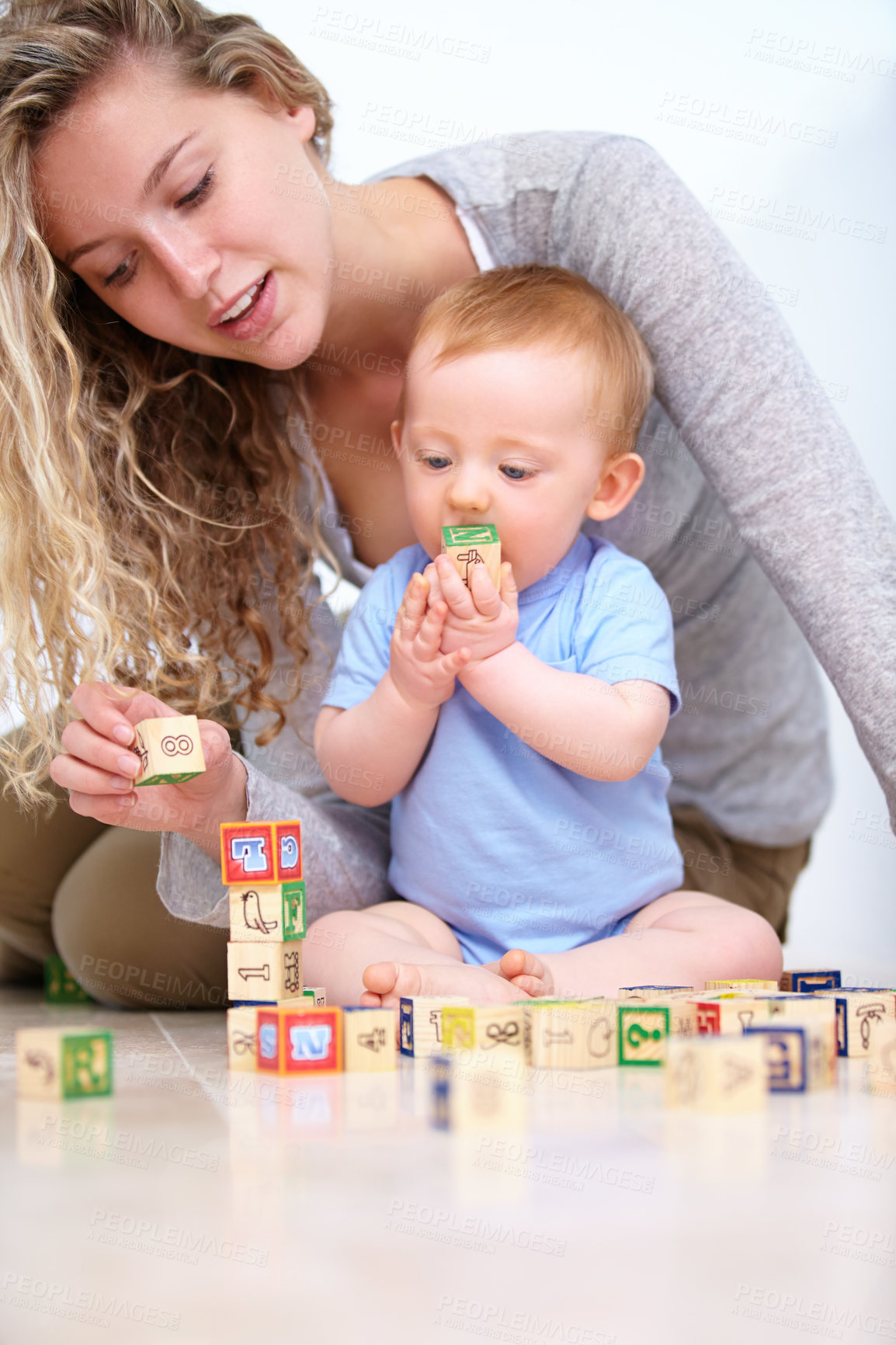 Buy stock photo Mom, baby and playing with wooden blocks or toys for childhood development or bonding at home. Mother, toddler and little boy learning shapes, letters or building together for fun activity at house