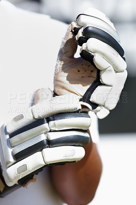 Buy stock photo Hands, cricket and athlete with gloves for competition, physical activity and outdoor summer training. Sports, contest and equipment for protection, workout or practice for match in stadium.
