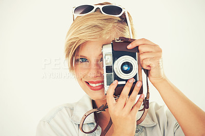 Buy stock photo Portrait of an attractive young woman standing with her camera in studio