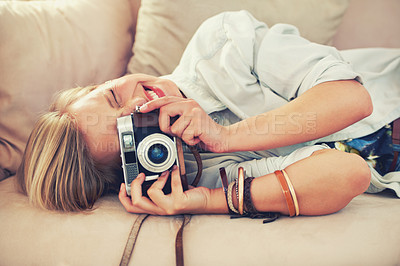 Buy stock photo Woman, camera and couch for retro, photography and fashion in casual outfit for hobby at home. Analog, lens or female photographer in trendy, creative and clothes for relax, shoot and freelance