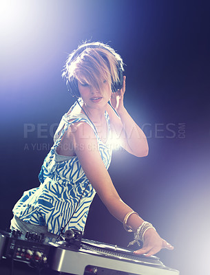 Buy stock photo Woman, dj and turntable with headphones for mixing on stage for concert, music and gig at rave party for entertainment. Female sound mixer, artist and musician with record player for playlist