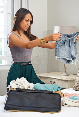 Buy stock photo Travel, clothes and woman packing luggage for vacation, planning and ready for holiday with bag. Jeans, person and suitcase in bedroom for trip preparation, journey or tourism with shorts at home