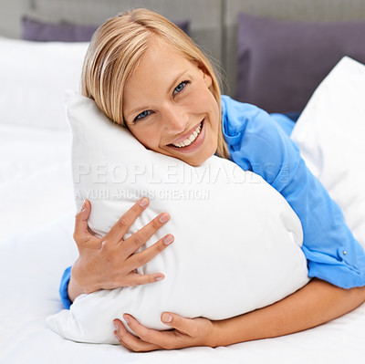 Buy stock photo Woman, bed and portrait with head on pillow in hotel room or indoors for vacation, calm and sleep. Happy person and smile for waking up and laying for comfort, rest and stress relief on holiday