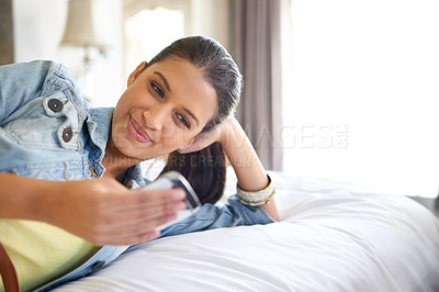 Buy stock photo Relax, woman and smile with phone in bedroom for social media, web search or browsing on internet. Female person, technology and happy in home with reading message, communication or scroll on website