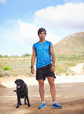 Buy stock photo Shot of a young man exercising outdoors with his dog