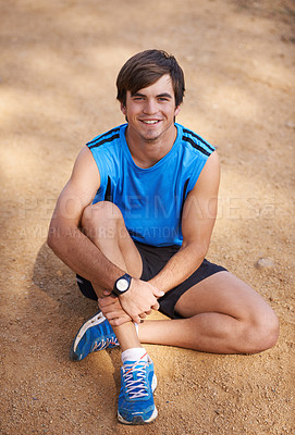 Buy stock photo Shot of a handsome young man exercising outdoors