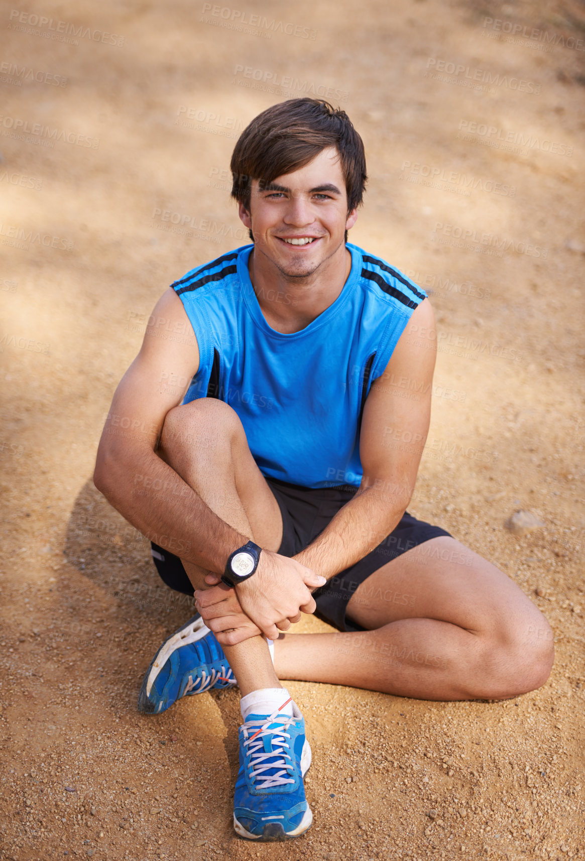 Buy stock photo Shot of a handsome young man exercising outdoors