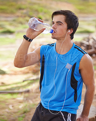 Buy stock photo Shot of a handsome young man exercising outdoors