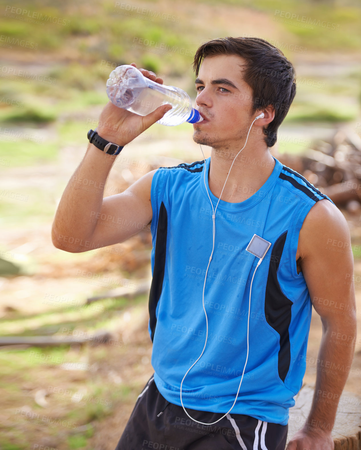 Buy stock photo Shot of a handsome young man exercising outdoors