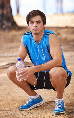 Buy stock photo Portrait, water or runner on break with earphones in outdoor exercise or fitness workout for podcast. Man, ready or male athlete listening to playlist for streaming radio, music or sports training