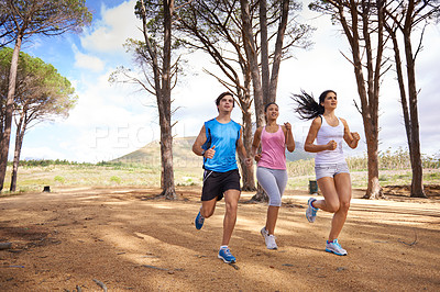 Buy stock photo Fitness, group or friends in nature running for exercise, training or outdoor workout together. People, fast runners or athletes at a park for sports endurance, wellness or cardio challenge in woods