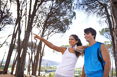 Buy stock photo Cropped shot of a young couple exercising in the forest