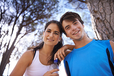 Buy stock photo Fitness, couple and portrait in nature smile, healthy and together for wellness and cardio workout. Relax, forest walk or athlete exercise, park for sports with trees or low angle happy people hiking