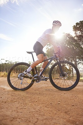 Buy stock photo Cyclist, man and bicycle ride in nature, hill and mountain biking in countryside. Male person, freedom and lens flare for fitness or exercise, hobby and sports for outdoor adventure and off road